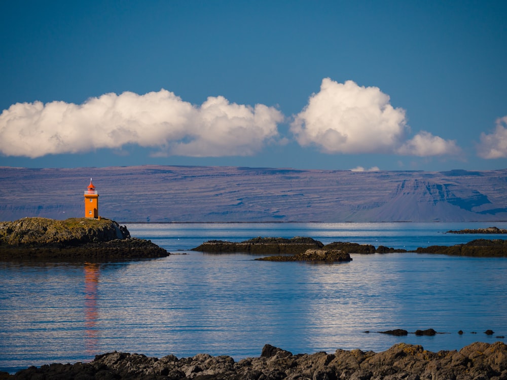 a lighthouse on an island in the middle of the ocean