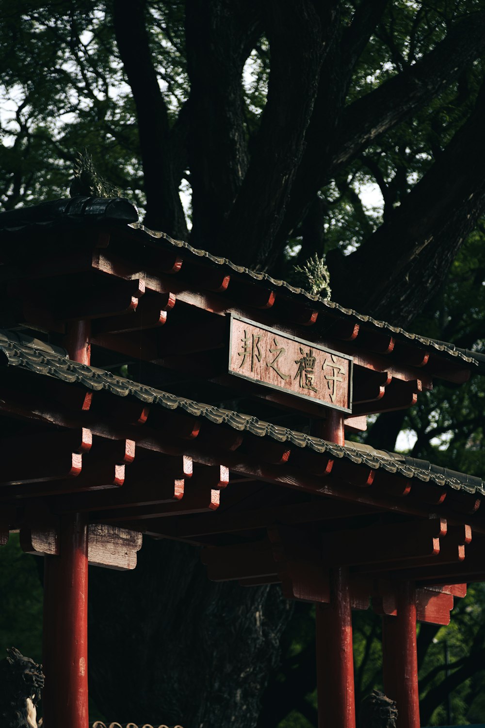 a wooden structure with a tree in the background