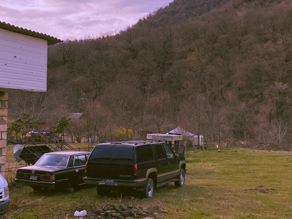 a couple of cars that are parked in the grass