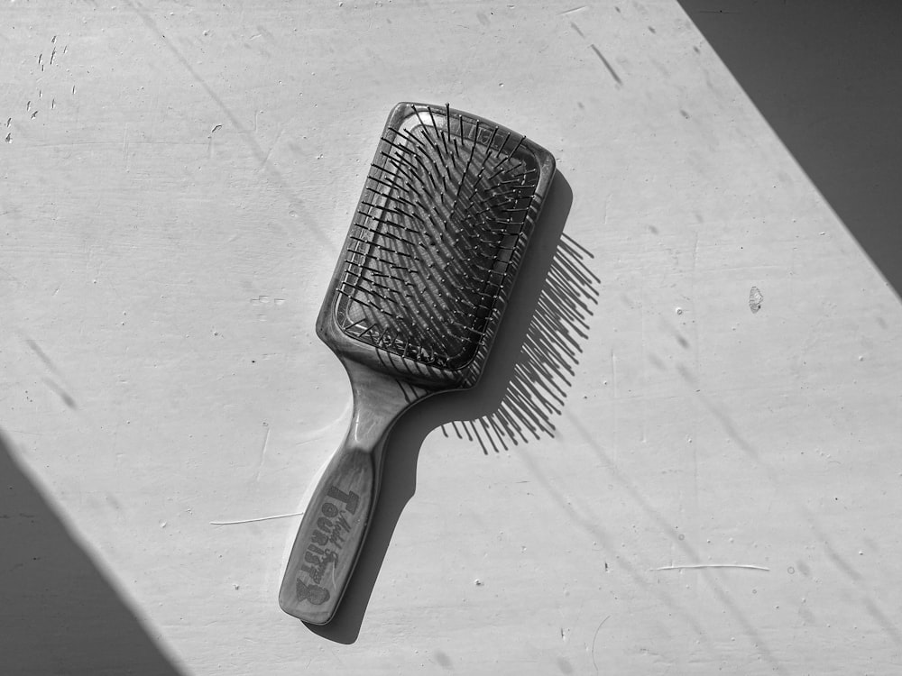 a black and white photo of a hair brush