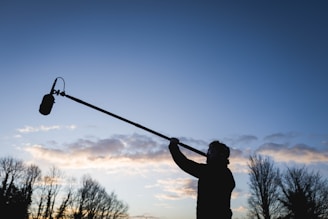 a man holding a pole with a light attached to it