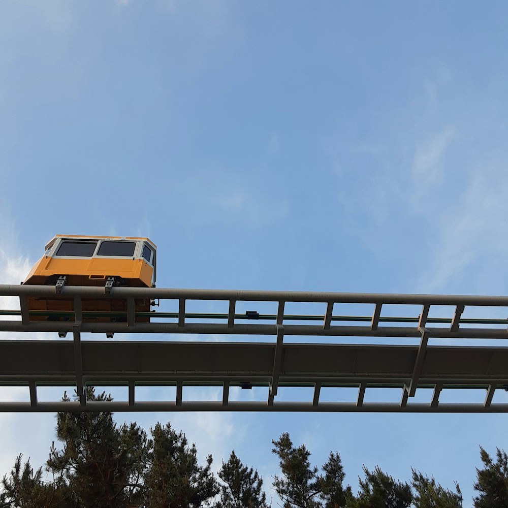 a yellow bus is going over a bridge