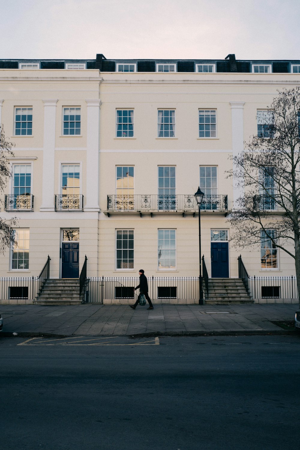 a person walking in front of a white building