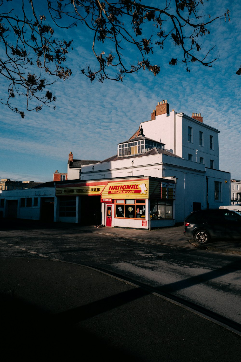 a large white building sitting on the side of a road