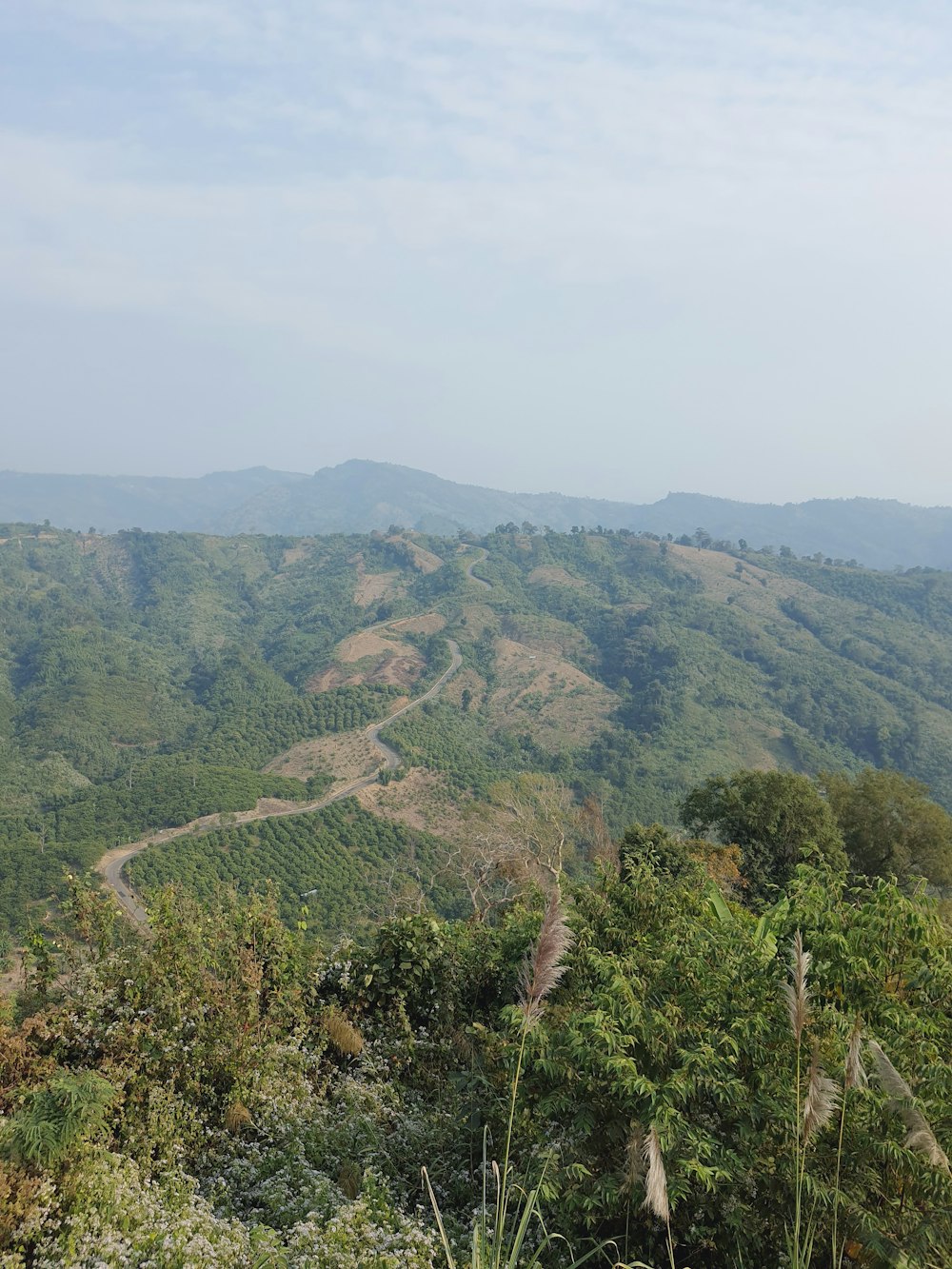 a scenic view of a winding road in the mountains