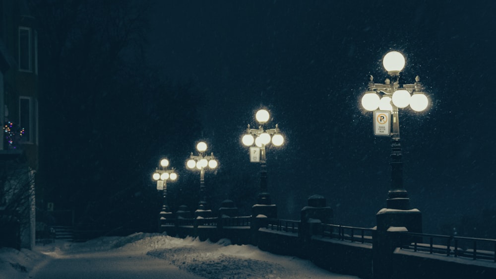 a street light on a snowy street at night