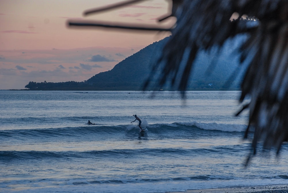 a person riding a surfboard on a wave in the ocean