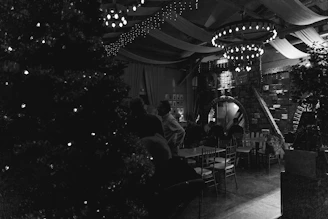A cozy Urfa sıra gecesi venue warmly lit with traditional decorations and happy guests.