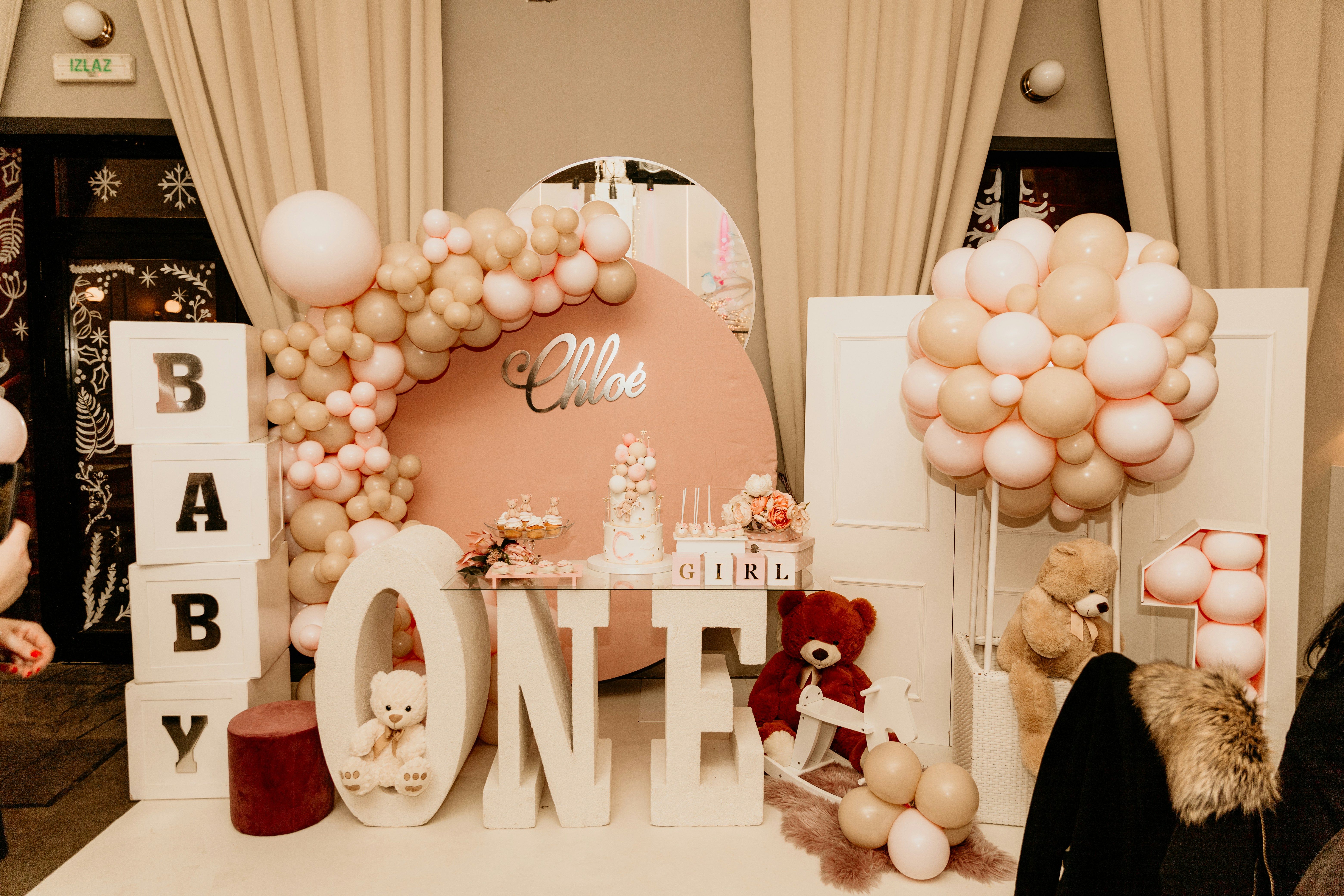 a table with balloons and a sign that says one