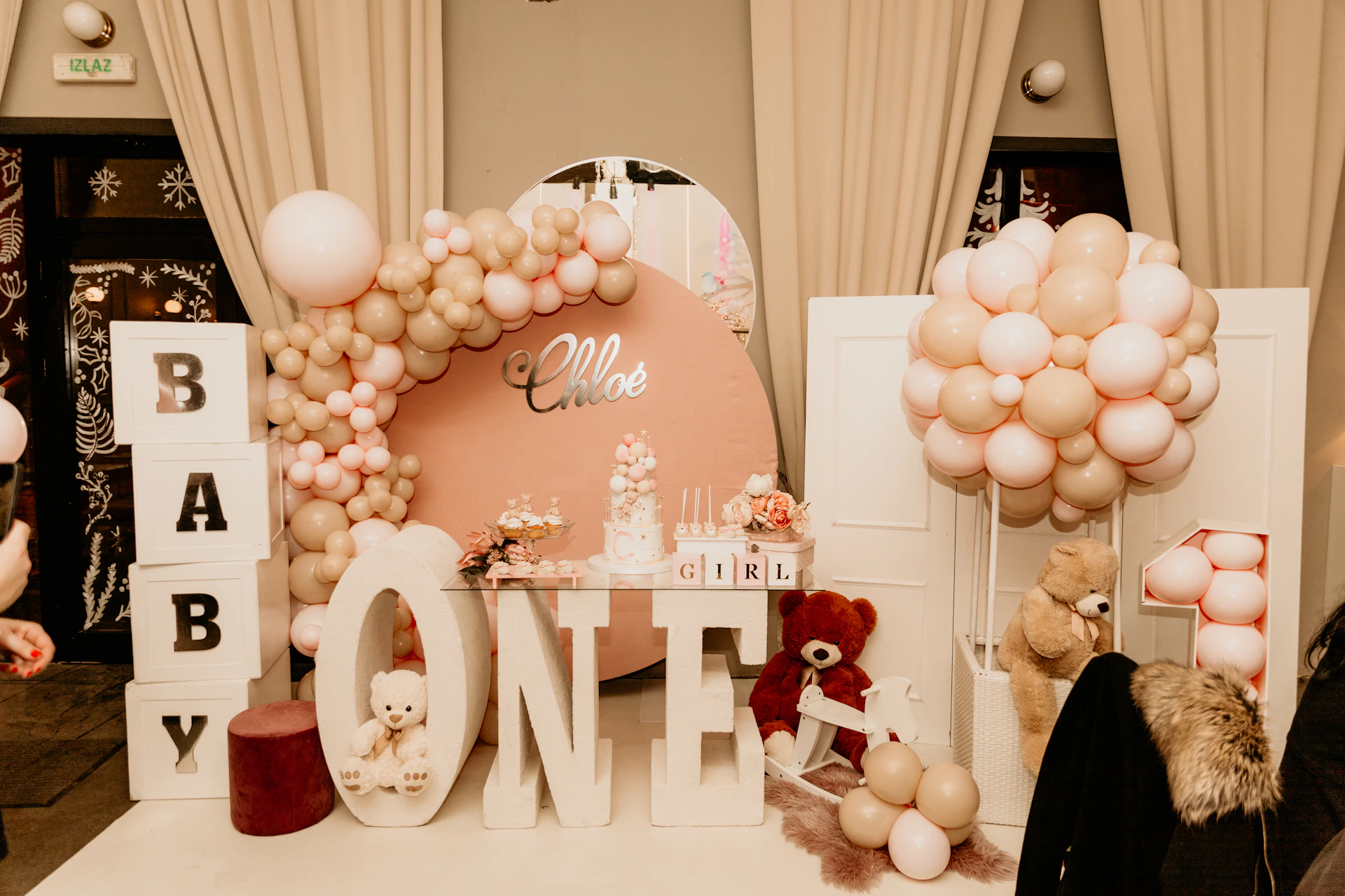 a table with balloons and a sign that says one
