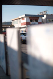 A clean white taxi car parked in front of a Taipei cityscape.