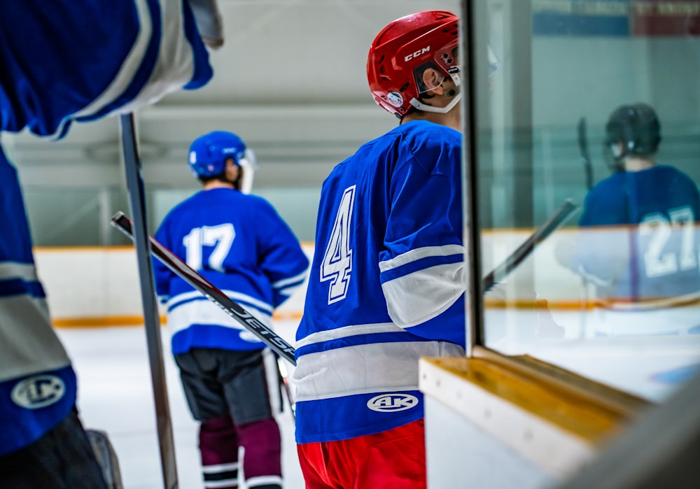 a hockey player in a blue jersey is looking out the window