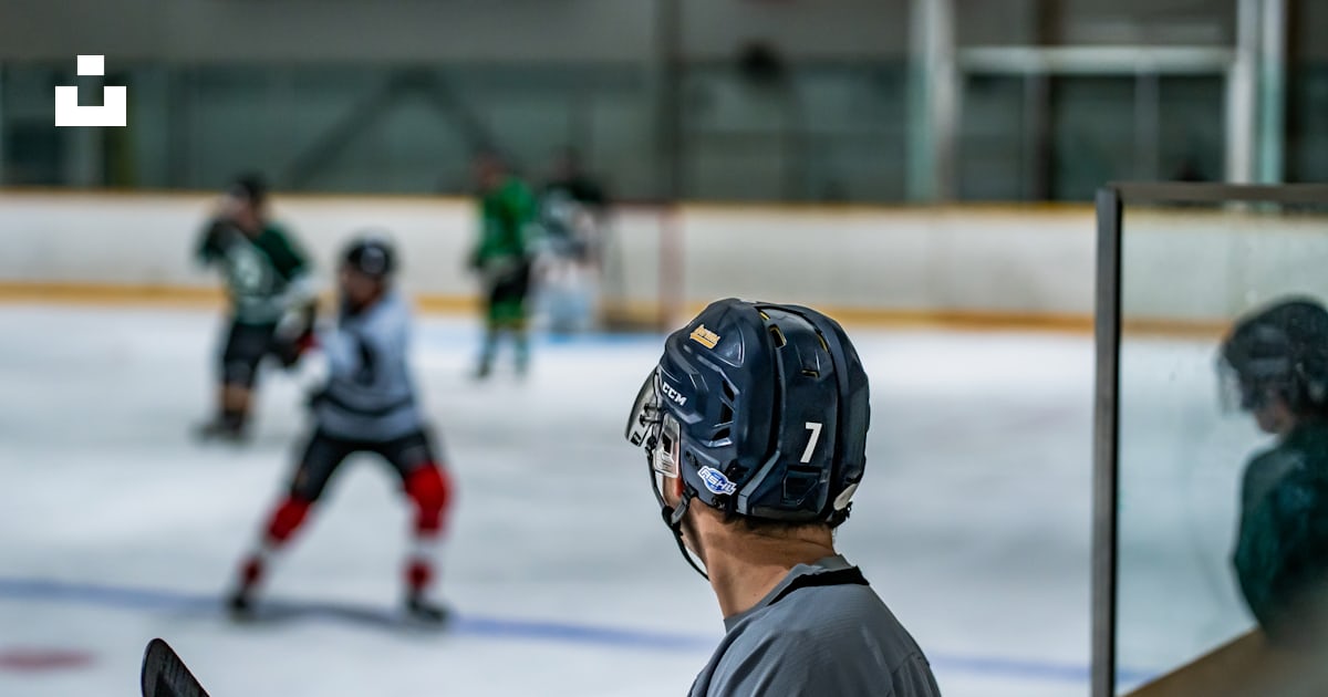 A Group Of Young Men Playing A Game Of Ice Hockey Photo Free Helmet a-group-of-young-men-playing-a-game-of-ice-hockey-photo-free-helmet