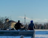 Comfortable seating area with a view of a snowy park and Canadian landmarks.