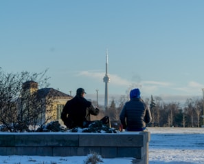 Comfortable seating area with a view of a snowy park and Canadian landmarks.