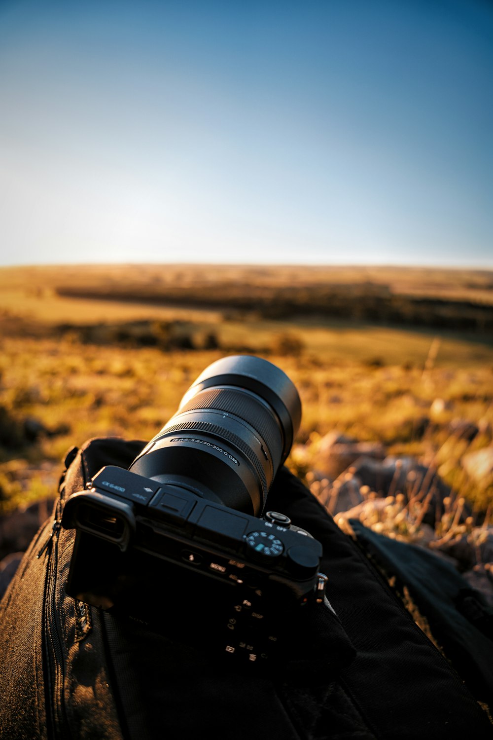 a camera sitting on top of a black bag