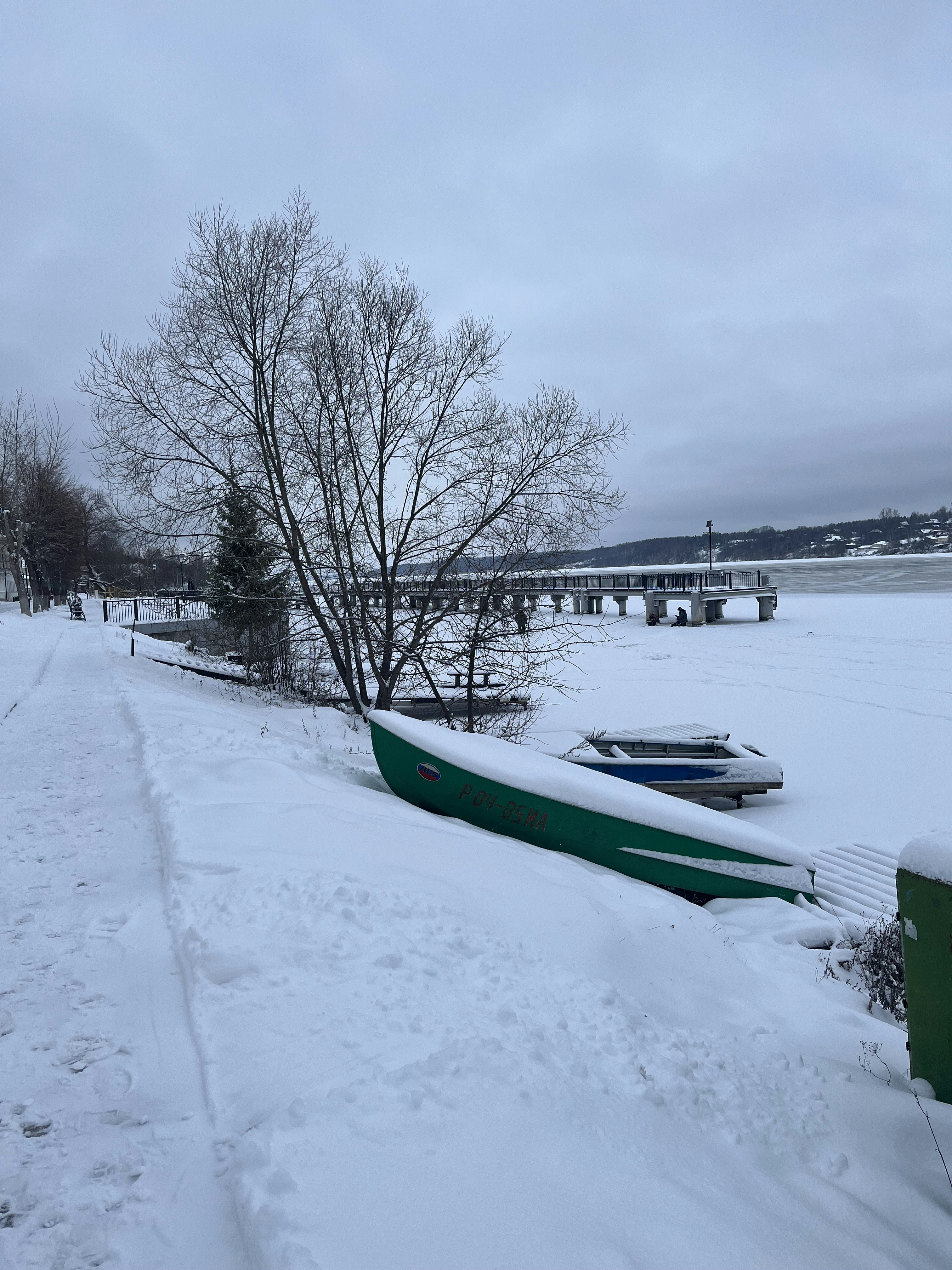 a boat sitting on top of snow covered ground