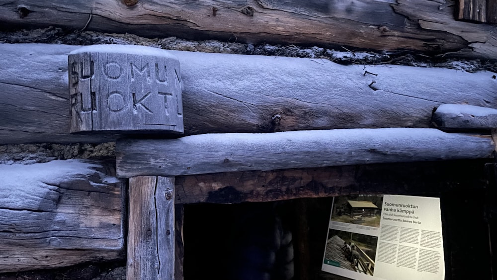 a close up of a wooden structure with a sign on it