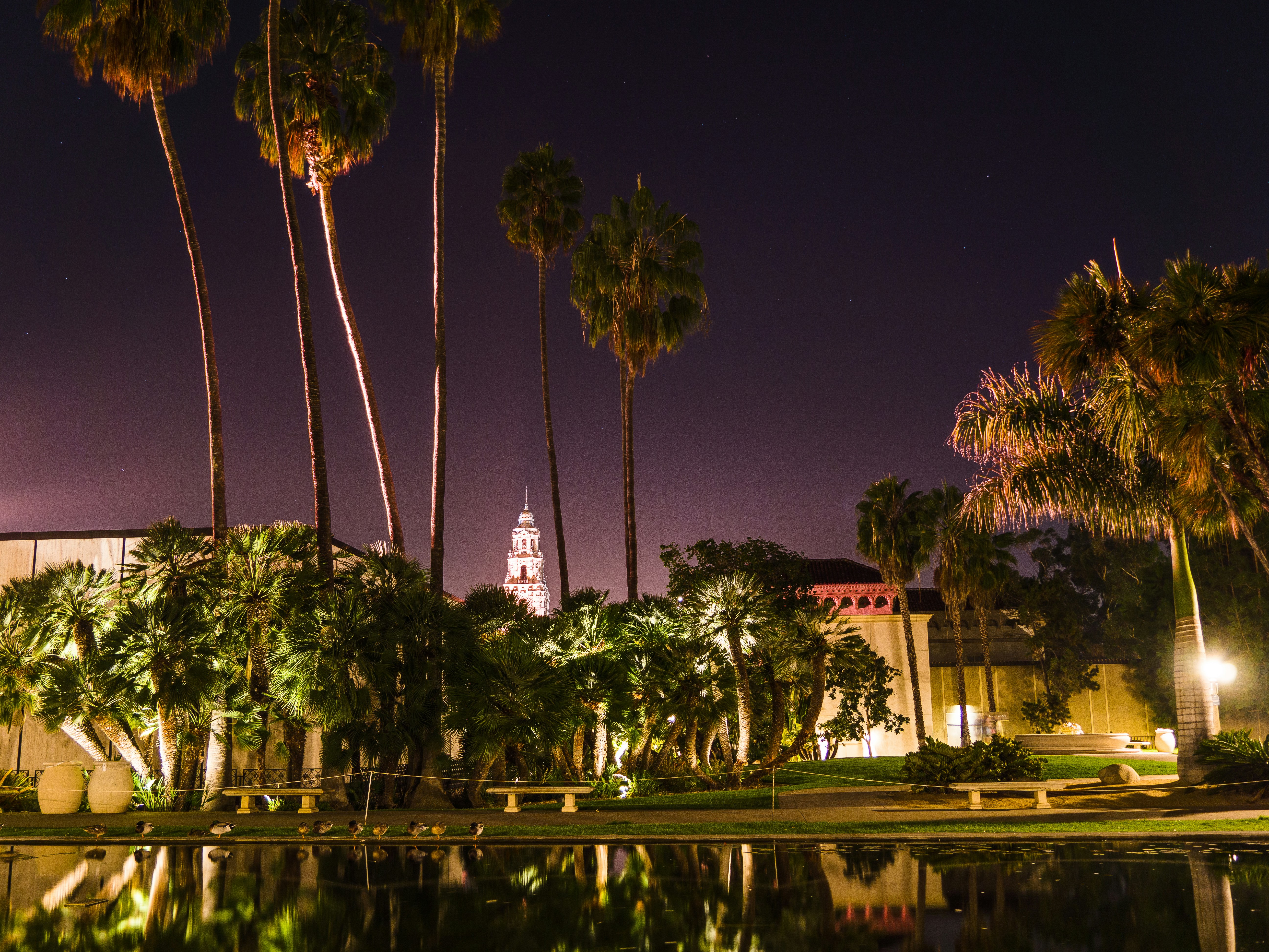 a building with a clock tower is lit up at night
