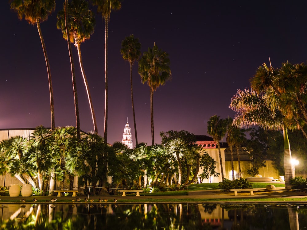 a building with a clock tower is lit up at night