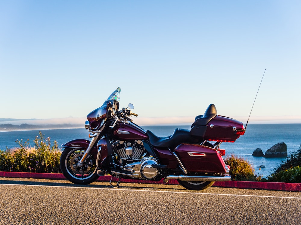 a red motorcycle parked on the side of the road