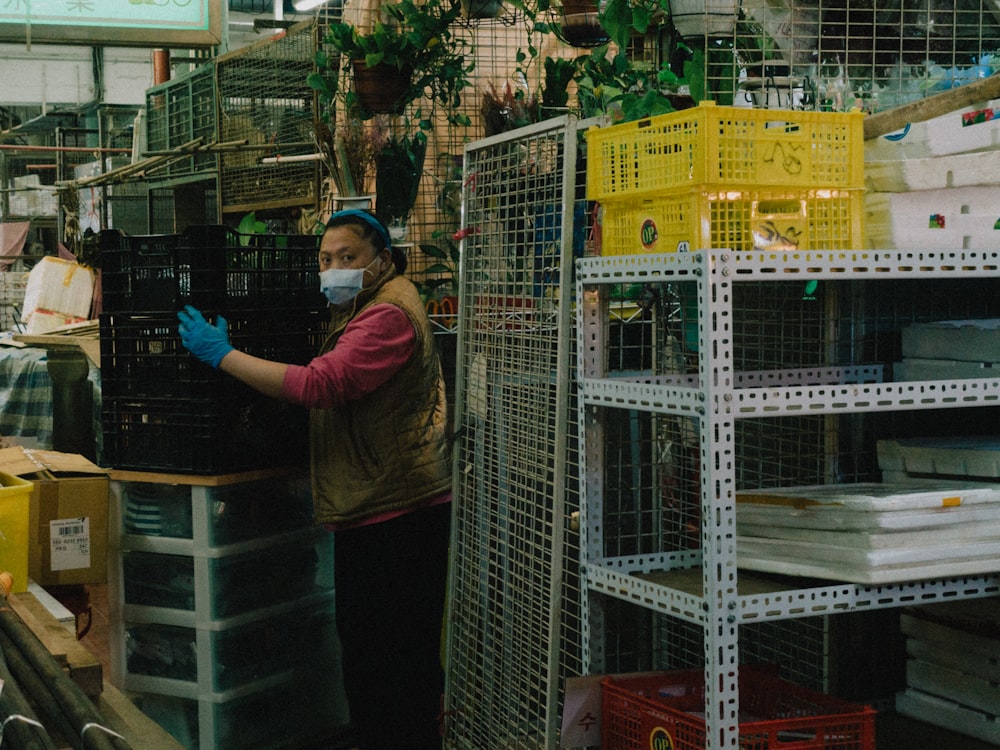 a woman wearing a face mask and gloves in a store