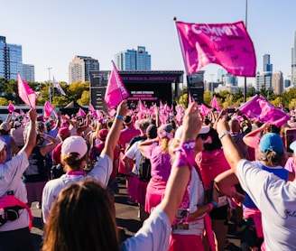 a large group of people with pink flags