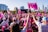 a large group of people with pink flags
