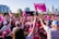 a large group of people with pink flags