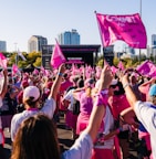 a large group of people with pink flags