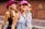 a group of young women walking down a street