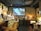 A cozy restaurant interior with warm lighting and a virtual overlay showing immersive spatial media.