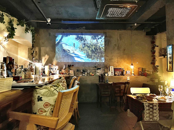 Cozy Scandinavian-style restaurant interior with warm lighting and a team planning social media content around a wooden table.