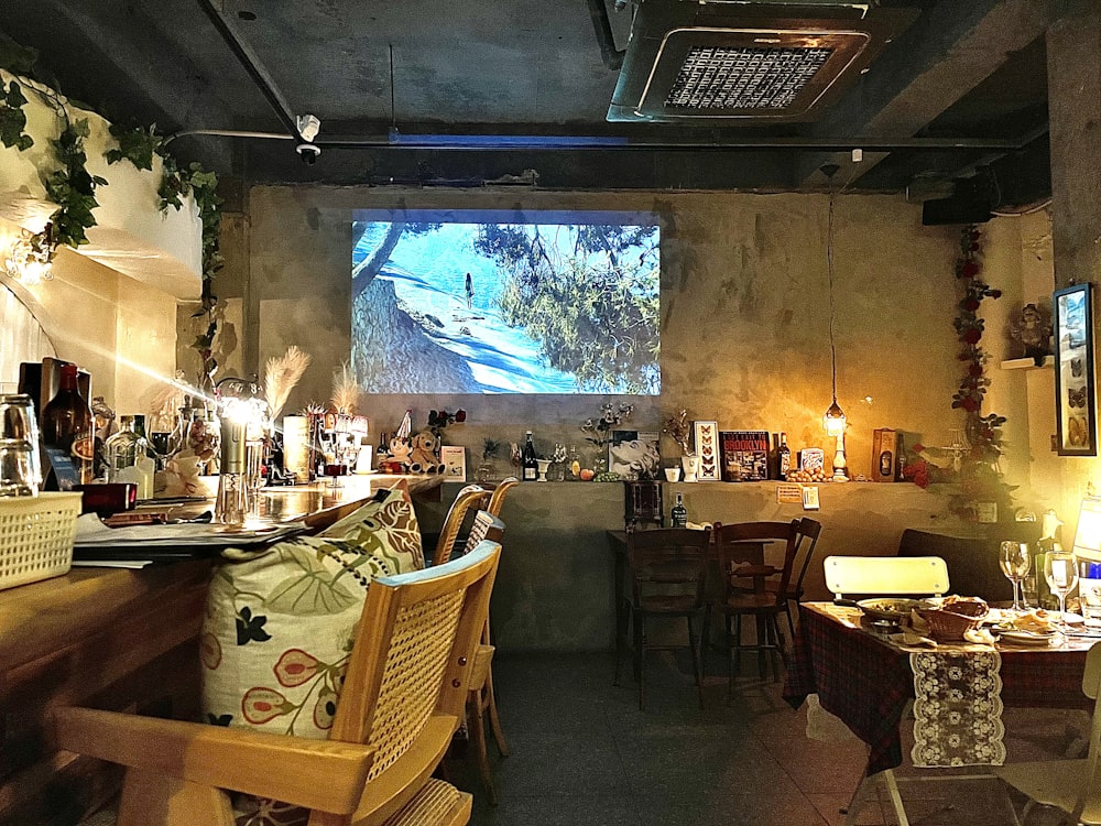 a restaurant with a large screen on the wall