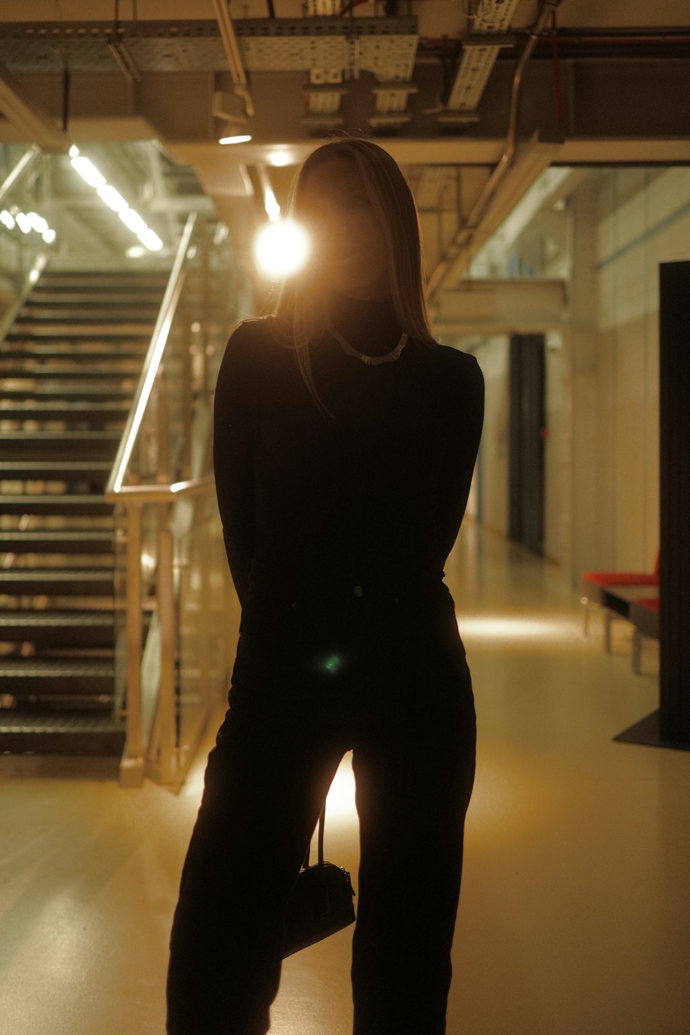 a woman standing in a dimly lit room