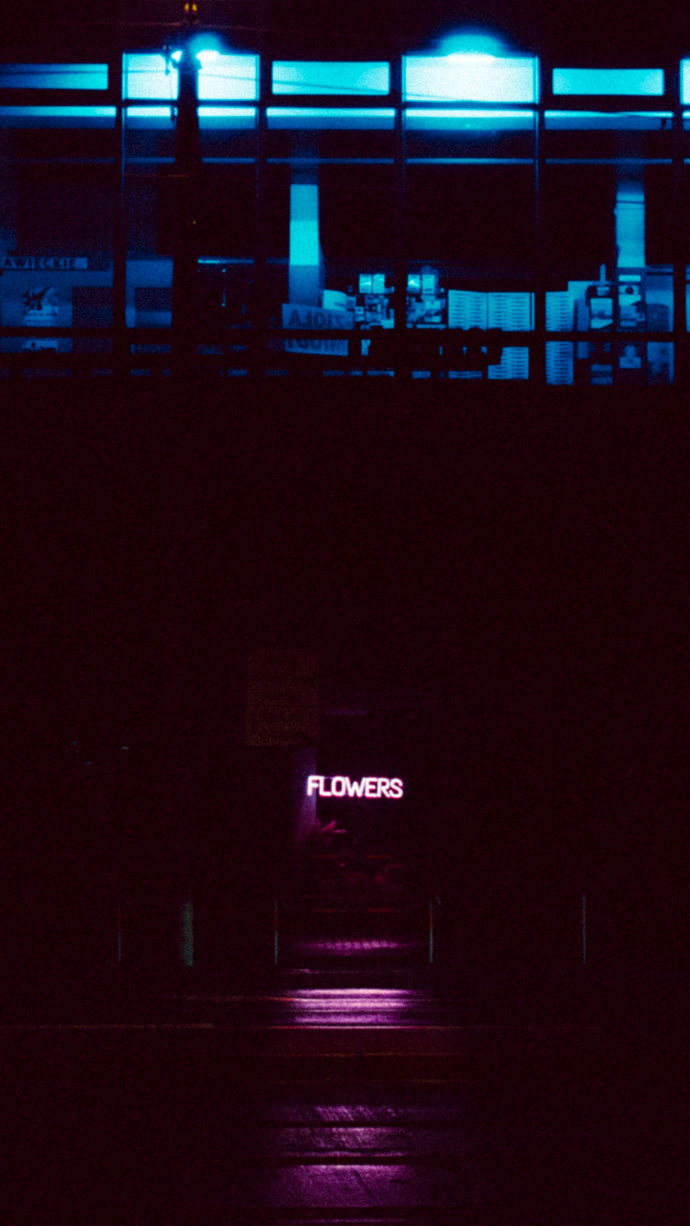 a building with a neon sign on the side of it