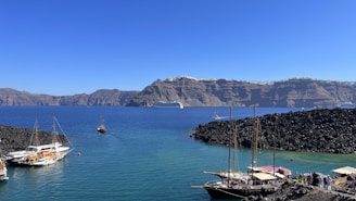 a group of boats floating on top of a body of water