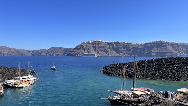 a group of boats floating on top of a body of water