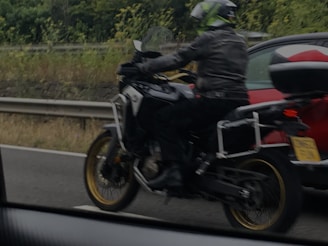 a person riding a motorcycle on a highway