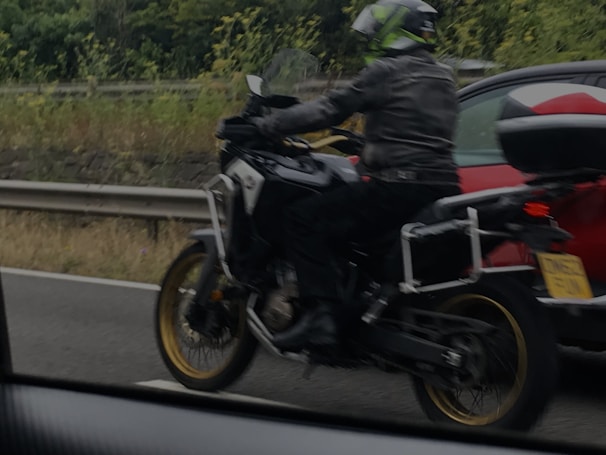 a person riding a motorcycle on a highway