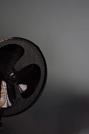 Industrial high-power wall fan installed in a busy Brazilian restaurant, showing robust design and airflow.