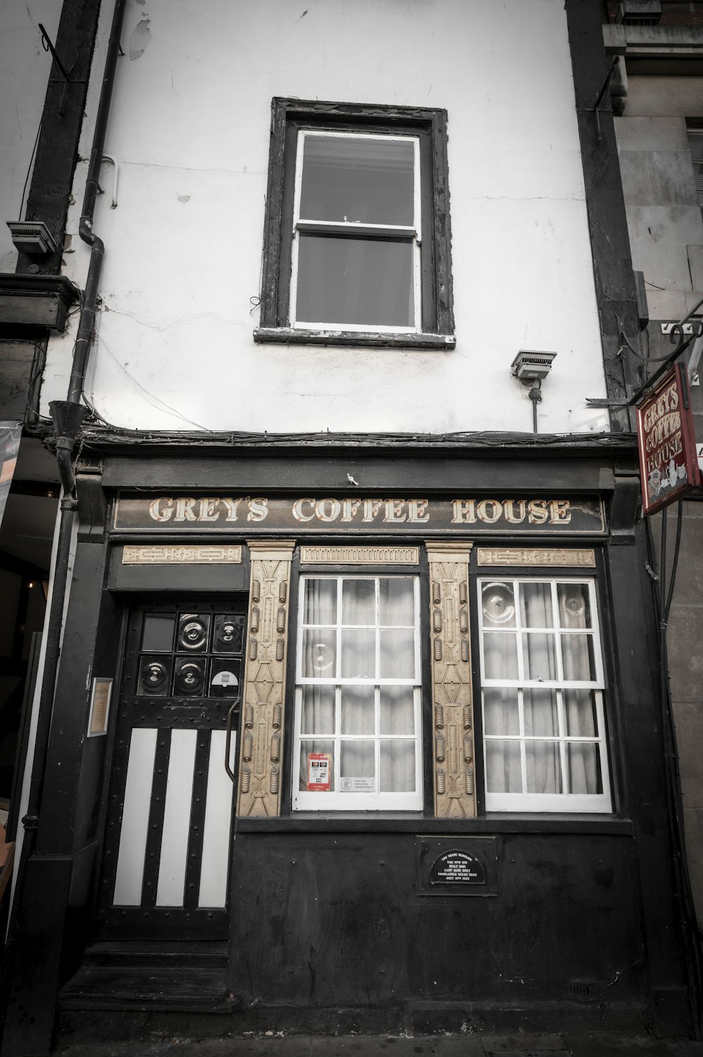 a black and white photo of a coffee house