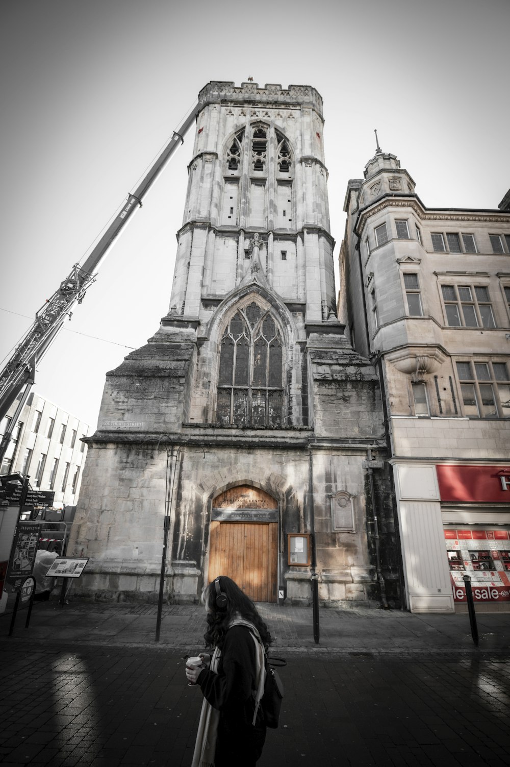 a person standing in front of a tall building