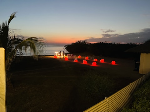 Elegant balloon garlands enhancing a surprise proposal setup at sunset.