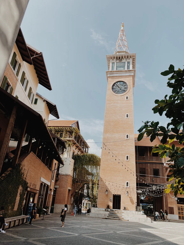 The brick clock tower of One Nimman rising above the open plaza of the Nimman district's shopping and dining complex.