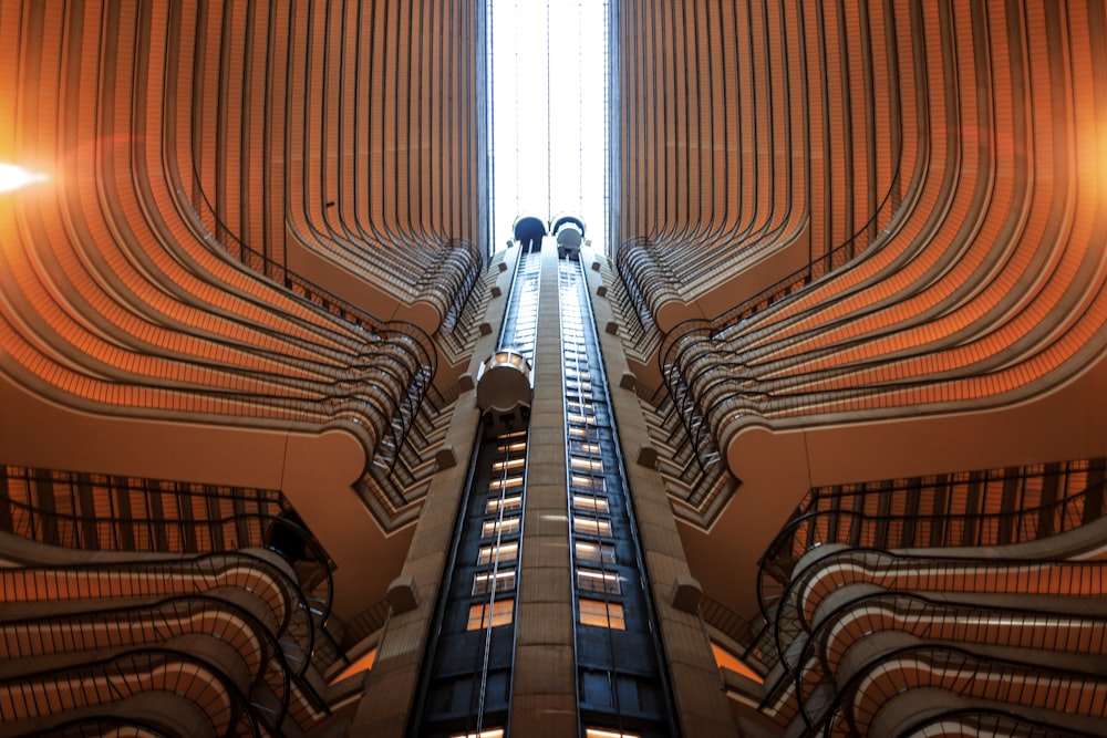 an escalator in a building with people walking up and down it