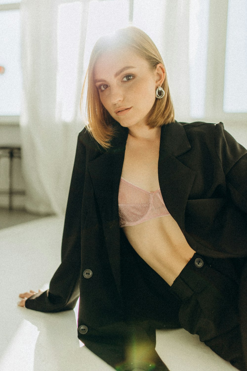 a woman in a black jacket sitting on a table