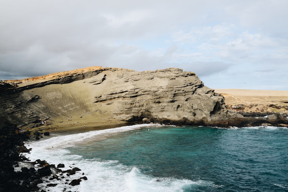 a rocky cliff overlooks a body of water