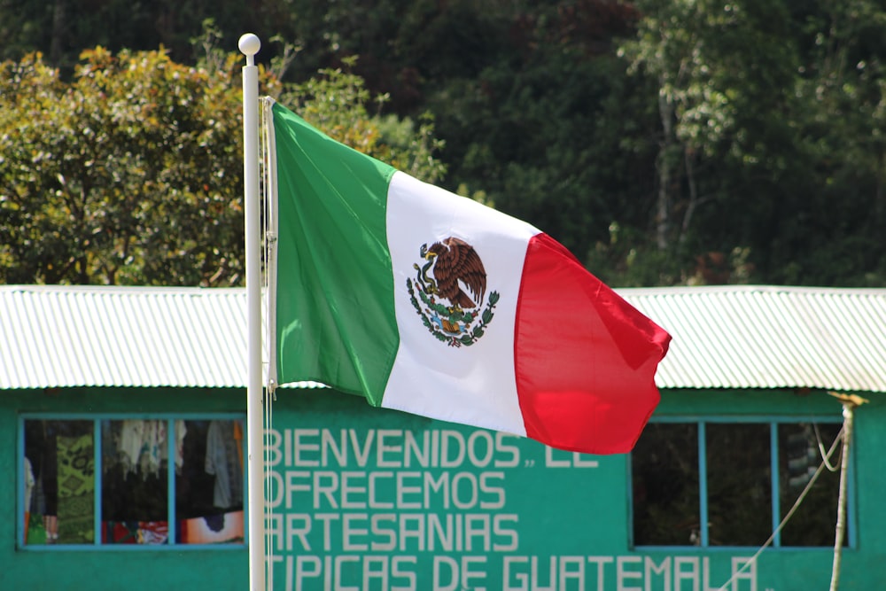 a mexican flag flying in front of a building