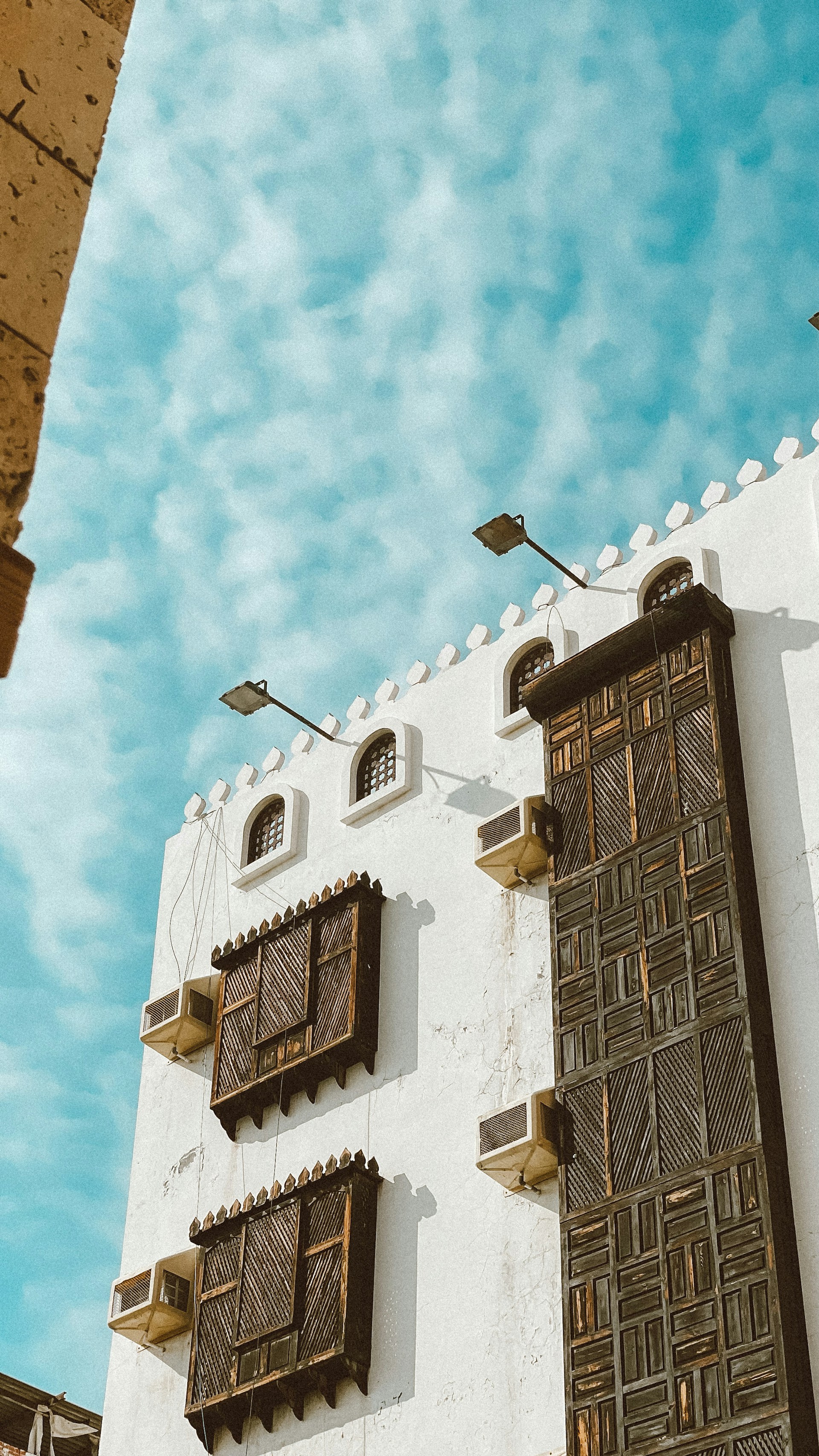 a tall white building with a clock on the side of it
